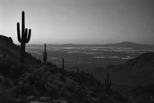 Illustration: Phoenix-area city lights across the desert valley at dusk. AI-generated scene of the location, not evidence.